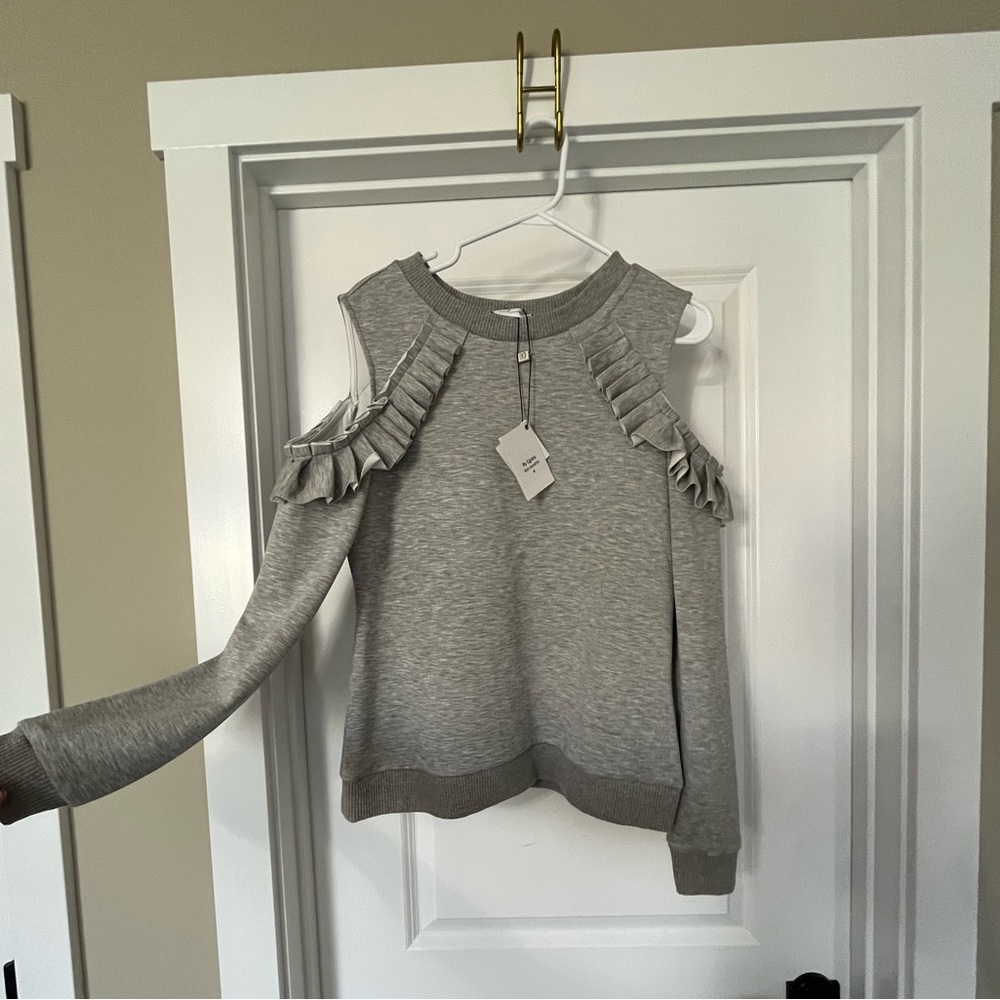 Cutout shoulder sweater with ruffles